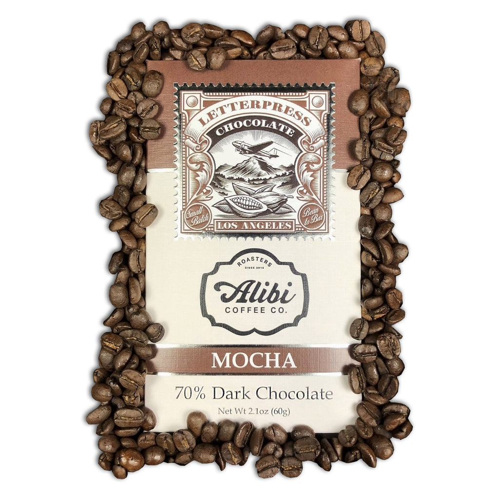 Mocha 70% Dark packaging surrounded by coffee beans on a white background