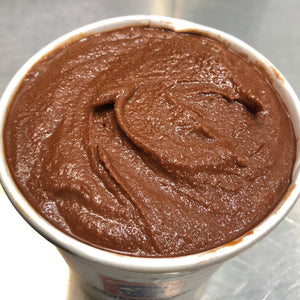 Detail of tanzania dark chocolate ice cream with the lid removed, showing the chocolate ice cream inside