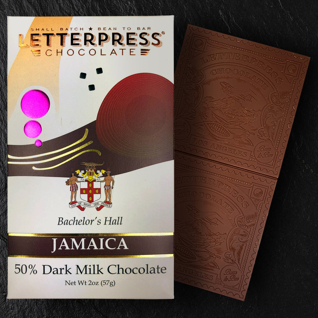 Jamaica 50% Dark MIlk Chocolate packaging and chocolate bar next to it on a slate background