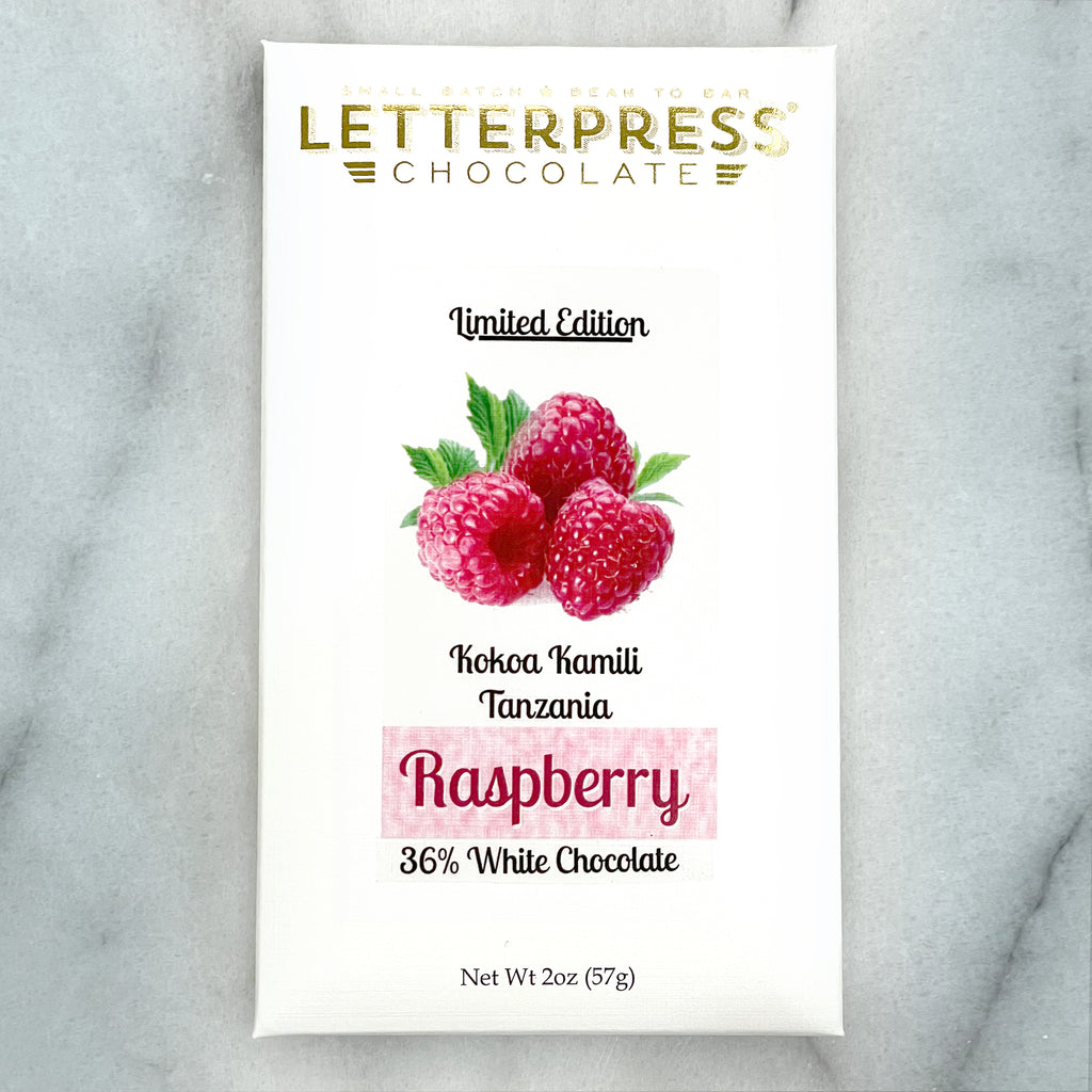 Raspberry White 36% White Chocolate packaging on a marble background