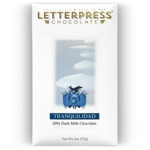 Tranquilidad 50% Dark Milk Chocolate packaging in all white with blue text and the coat of arms of Peru